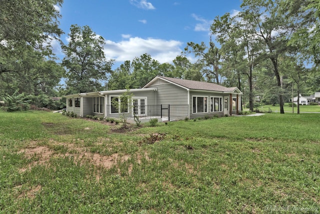 rear view of house with a lawn