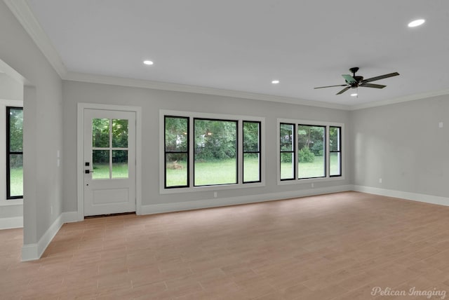 unfurnished living room with light hardwood / wood-style floors, crown molding, ceiling fan, and a healthy amount of sunlight