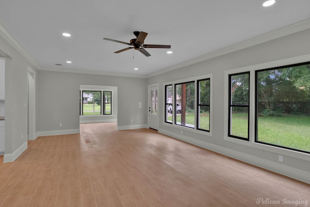 unfurnished room with light wood-type flooring, plenty of natural light, and crown molding