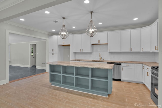 kitchen featuring a center island, white cabinets, stainless steel dishwasher, light wood-type flooring, and decorative light fixtures