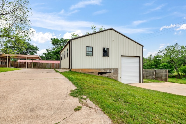 view of outbuilding with a garage and a yard