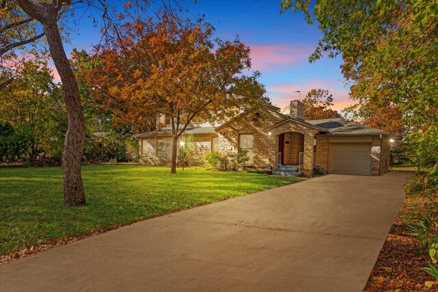 view of front of property with a yard and a garage