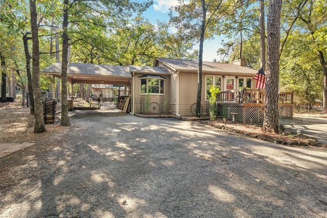 ranch-style home with a carport and a wooden deck