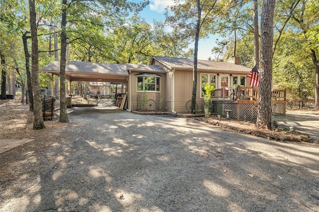 view of front facade featuring a carport and a deck