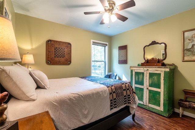 bedroom with dark hardwood / wood-style floors and ceiling fan