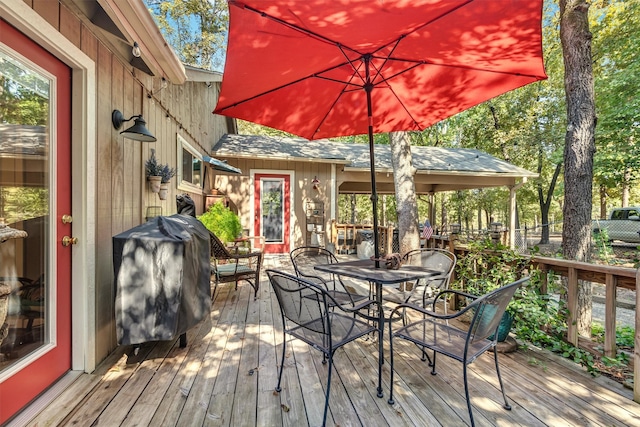 wooden terrace featuring a grill