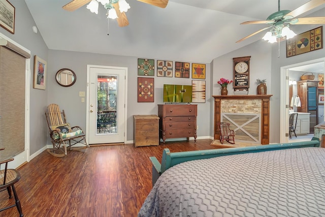 bedroom featuring lofted ceiling, access to exterior, dark hardwood / wood-style floors, ceiling fan, and a fireplace