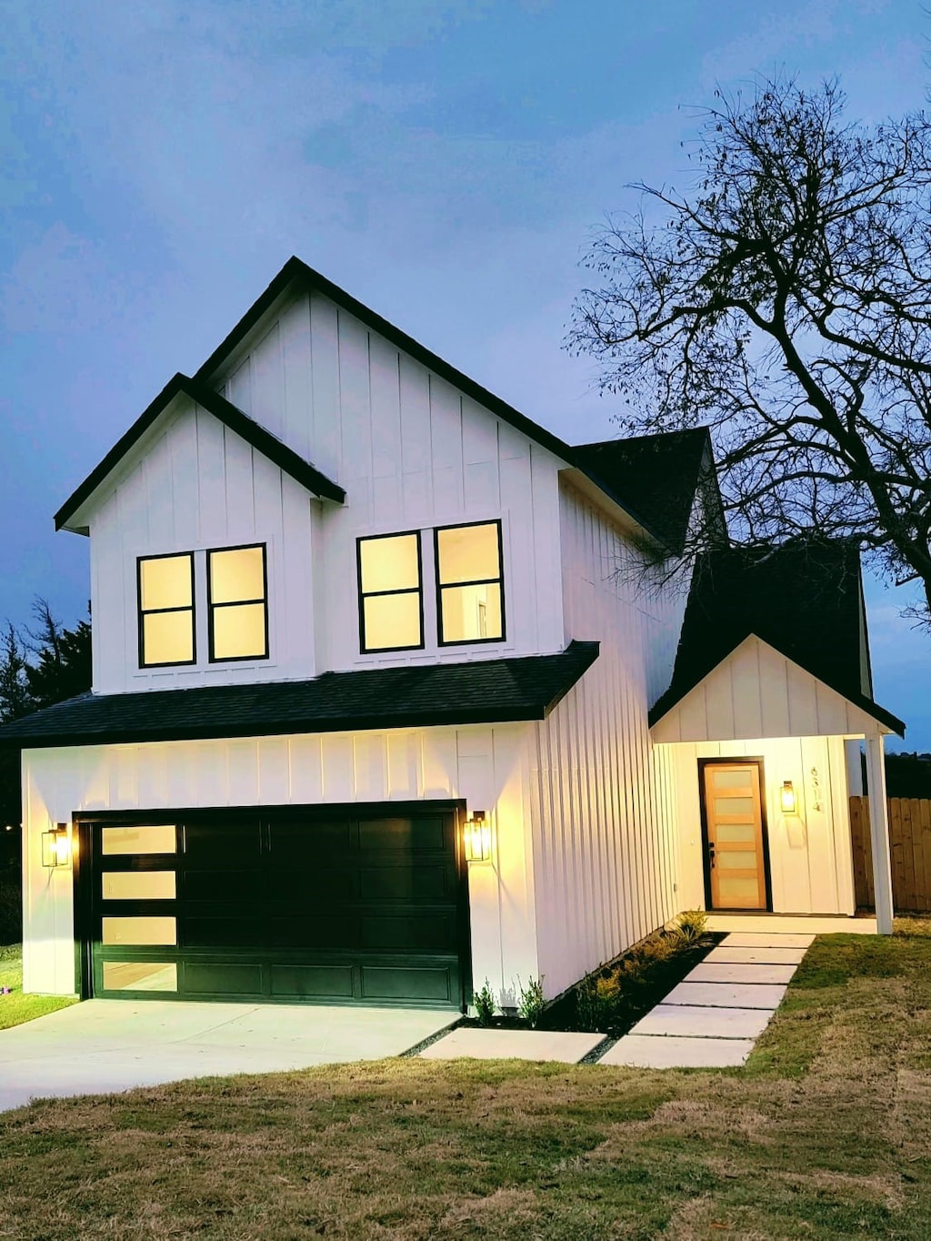 modern inspired farmhouse featuring a garage