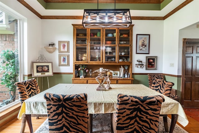 dining space featuring hardwood / wood-style flooring and crown molding