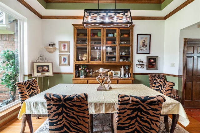 dining area featuring hardwood / wood-style flooring and ornamental molding