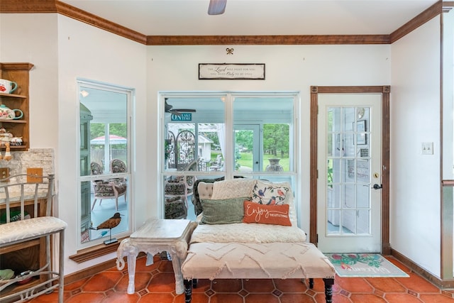 interior space featuring tile patterned floors, a wealth of natural light, ornamental molding, and ceiling fan