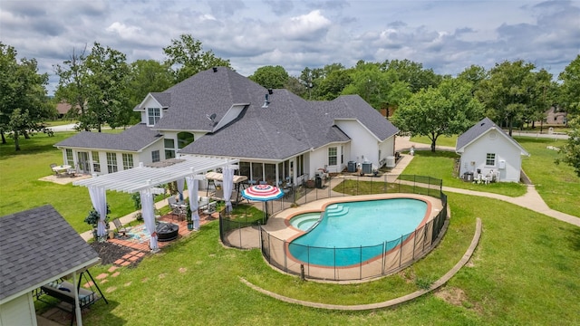 view of pool with an outbuilding, a pergola, and a patio