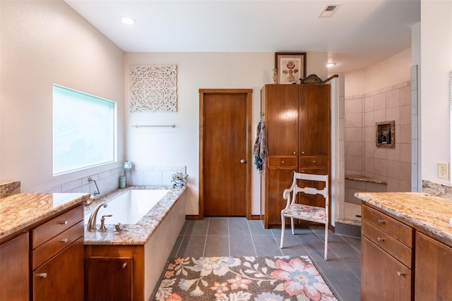 bathroom with vanity, a bathtub, and tile patterned floors