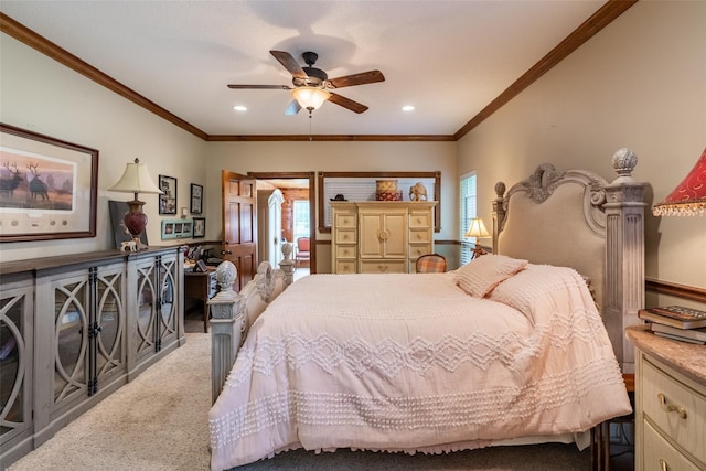 carpeted bedroom with ceiling fan and ornamental molding