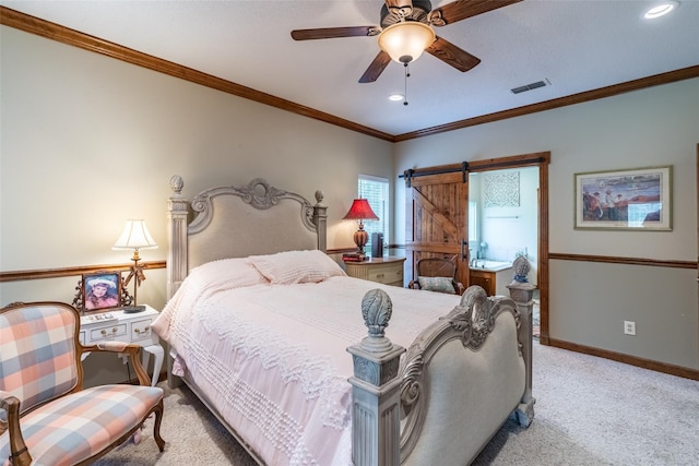 bedroom featuring ceiling fan, a barn door, ornamental molding, and light carpet