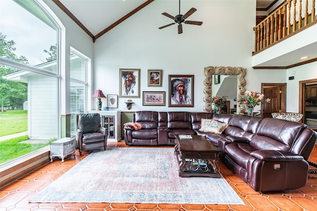 living room with crown molding, ceiling fan, and high vaulted ceiling