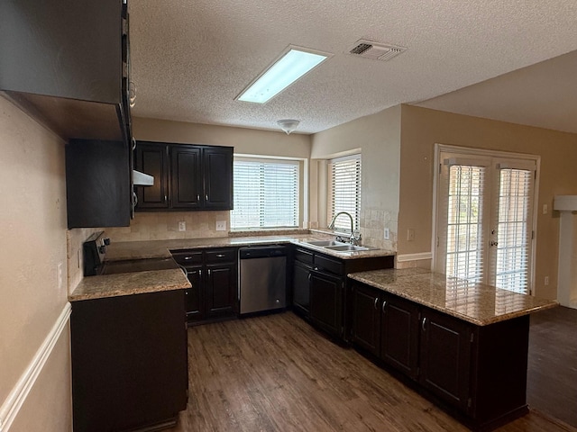 kitchen featuring appliances with stainless steel finishes, french doors, sink, dark hardwood / wood-style floors, and plenty of natural light