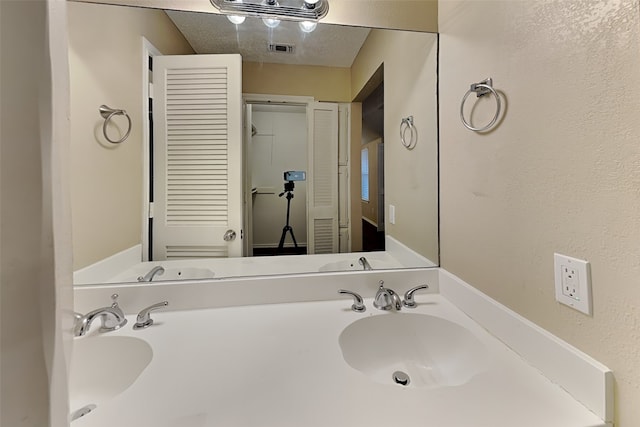 bathroom featuring vanity and a textured ceiling