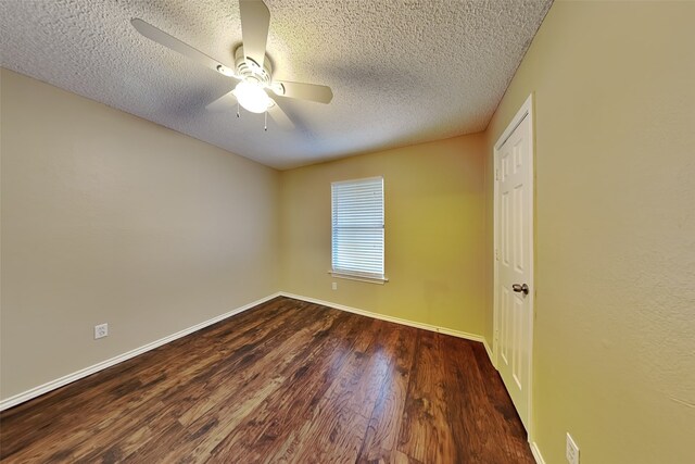 empty room with a textured ceiling, ceiling fan, and dark wood-type flooring