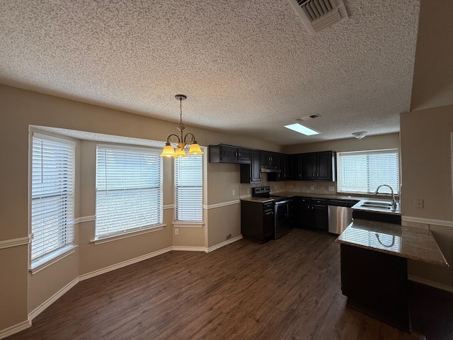 kitchen with sink, dark wood-type flooring, hanging light fixtures, a chandelier, and appliances with stainless steel finishes