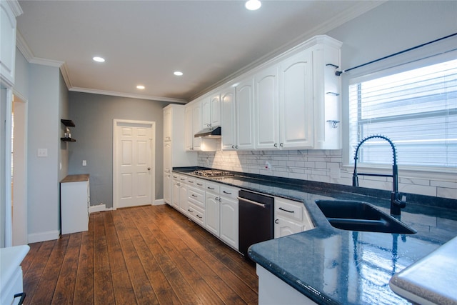 kitchen featuring sink, dark hardwood / wood-style floors, white cabinets, stainless steel gas stovetop, and backsplash