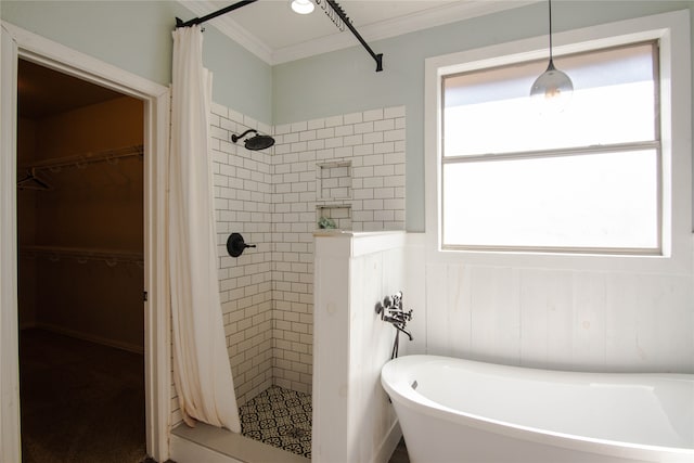 bathroom featuring ornamental molding and separate shower and tub