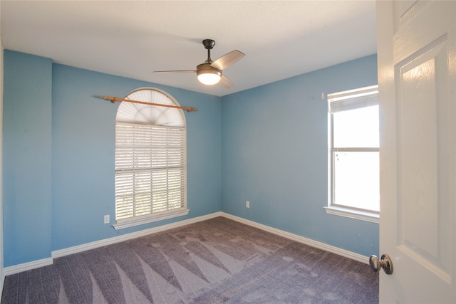 unfurnished room with carpet and ceiling fan