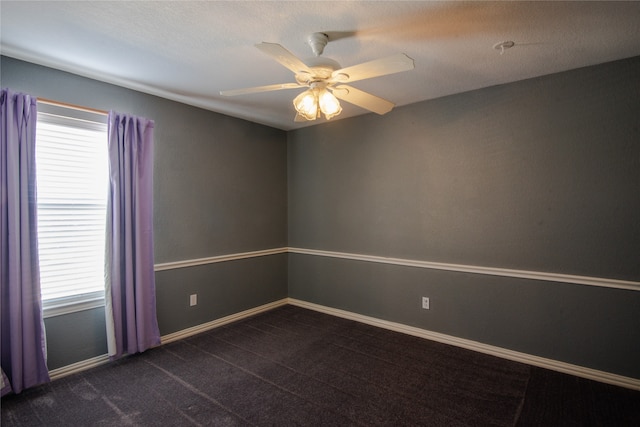 carpeted empty room with ceiling fan and a healthy amount of sunlight