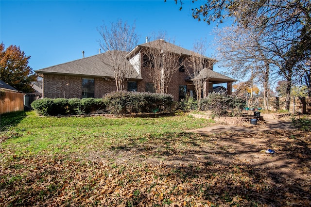 back of house with a lawn