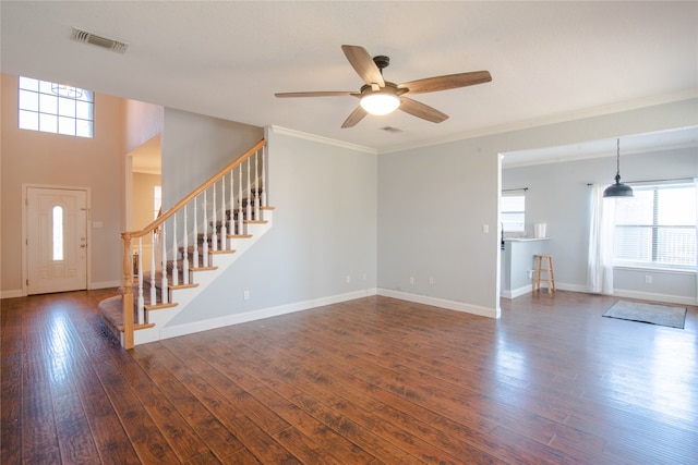 unfurnished living room featuring crown molding, dark wood-type flooring, and ceiling fan