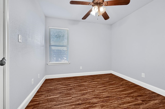 spare room featuring ceiling fan and dark wood-type flooring