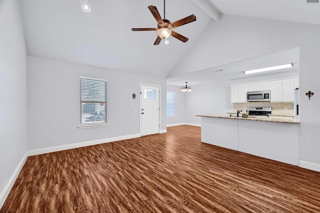 unfurnished living room featuring sink, dark hardwood / wood-style flooring, beamed ceiling, high vaulted ceiling, and ceiling fan with notable chandelier