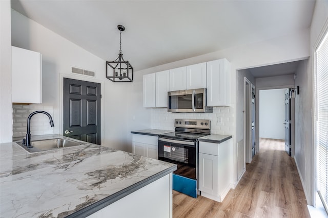 kitchen featuring stainless steel appliances, sink, light hardwood / wood-style flooring, white cabinets, and lofted ceiling