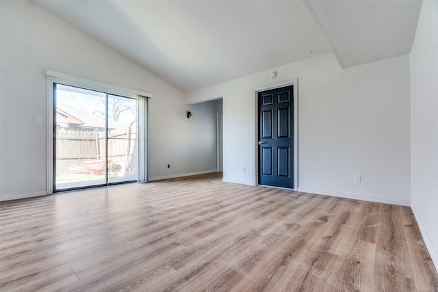 empty room featuring light hardwood / wood-style flooring and lofted ceiling