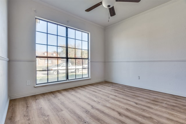 empty room with ceiling fan, light hardwood / wood-style flooring, a healthy amount of sunlight, and ornamental molding