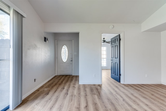 foyer entrance with light hardwood / wood-style flooring and ceiling fan