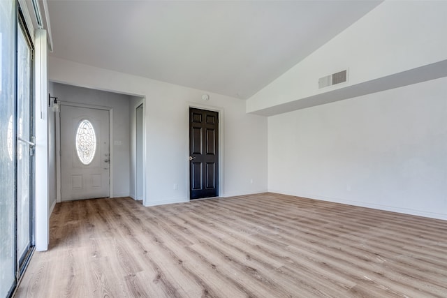 foyer featuring vaulted ceiling and light hardwood / wood-style floors