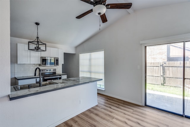 kitchen featuring a healthy amount of sunlight, white cabinetry, and stainless steel appliances