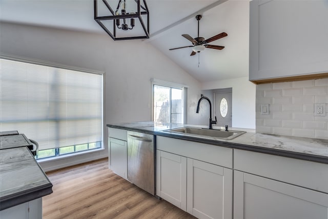 kitchen featuring stainless steel dishwasher, sink, light hardwood / wood-style flooring, white cabinets, and vaulted ceiling with beams