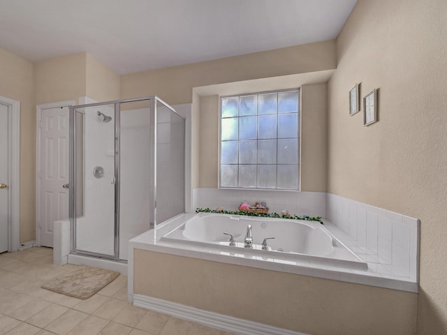 full bath with a garden tub, a shower stall, and tile patterned flooring