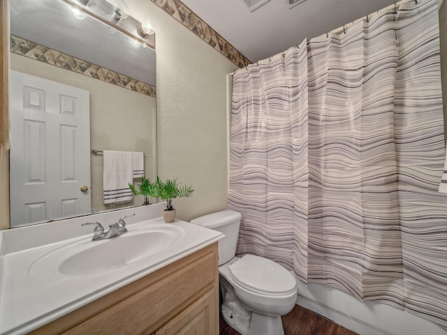 full bathroom with hardwood / wood-style floors, a textured ceiling, toilet, shower / bath combo with shower curtain, and vanity