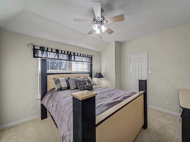 bedroom featuring baseboards, vaulted ceiling, a ceiling fan, and light colored carpet