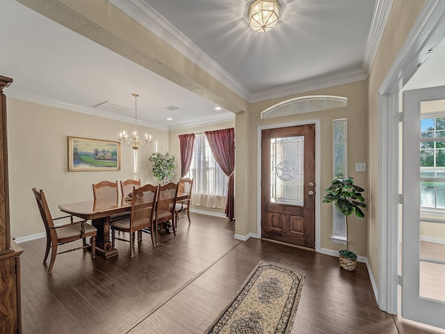 entrance foyer featuring ornamental molding, dark hardwood / wood-style flooring, and a notable chandelier