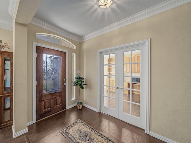 entrance foyer with baseboards, dark wood finished floors, crown molding, and french doors