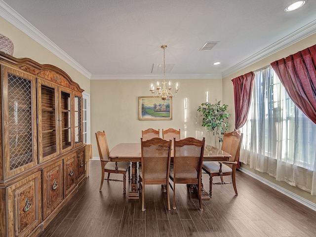 dining area featuring dark hardwood / wood-style flooring, an inviting chandelier, and ornamental molding