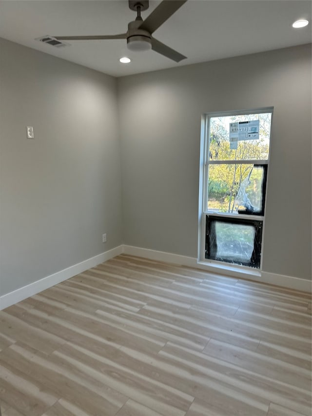 empty room with ceiling fan and light wood-type flooring