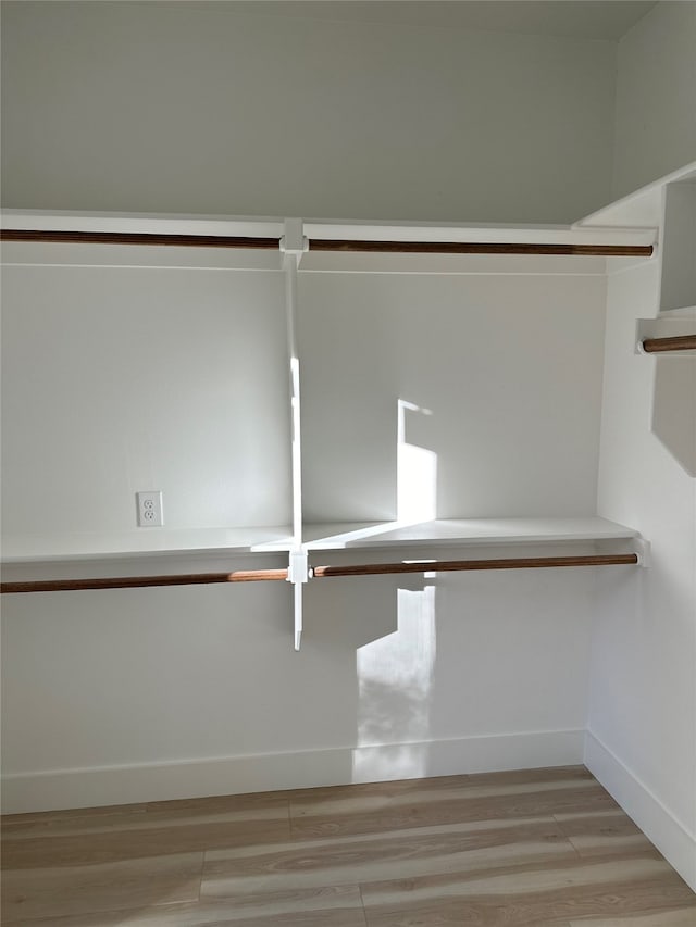 spacious closet featuring light hardwood / wood-style flooring