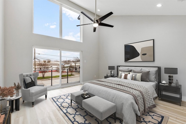 bedroom with access to exterior, light hardwood / wood-style flooring, and ceiling fan