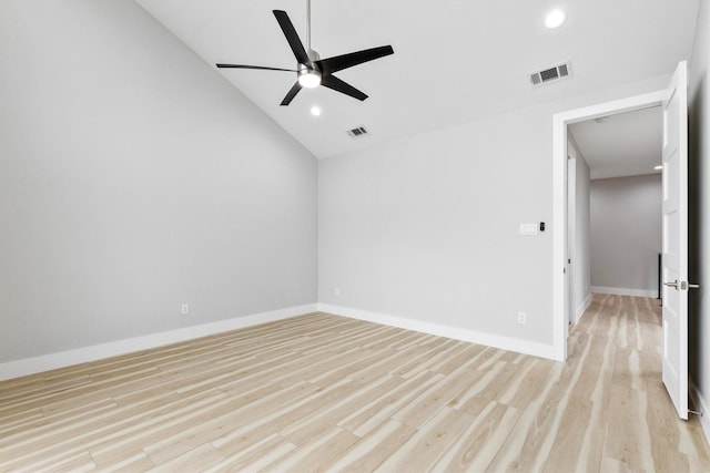 spare room featuring ceiling fan, vaulted ceiling, and light wood-type flooring