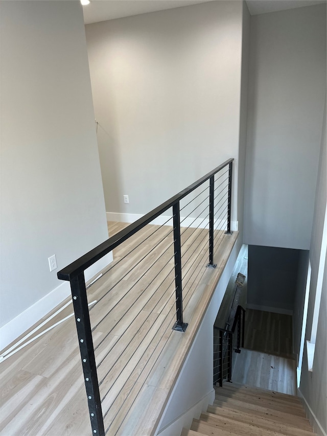 stairway with hardwood / wood-style flooring